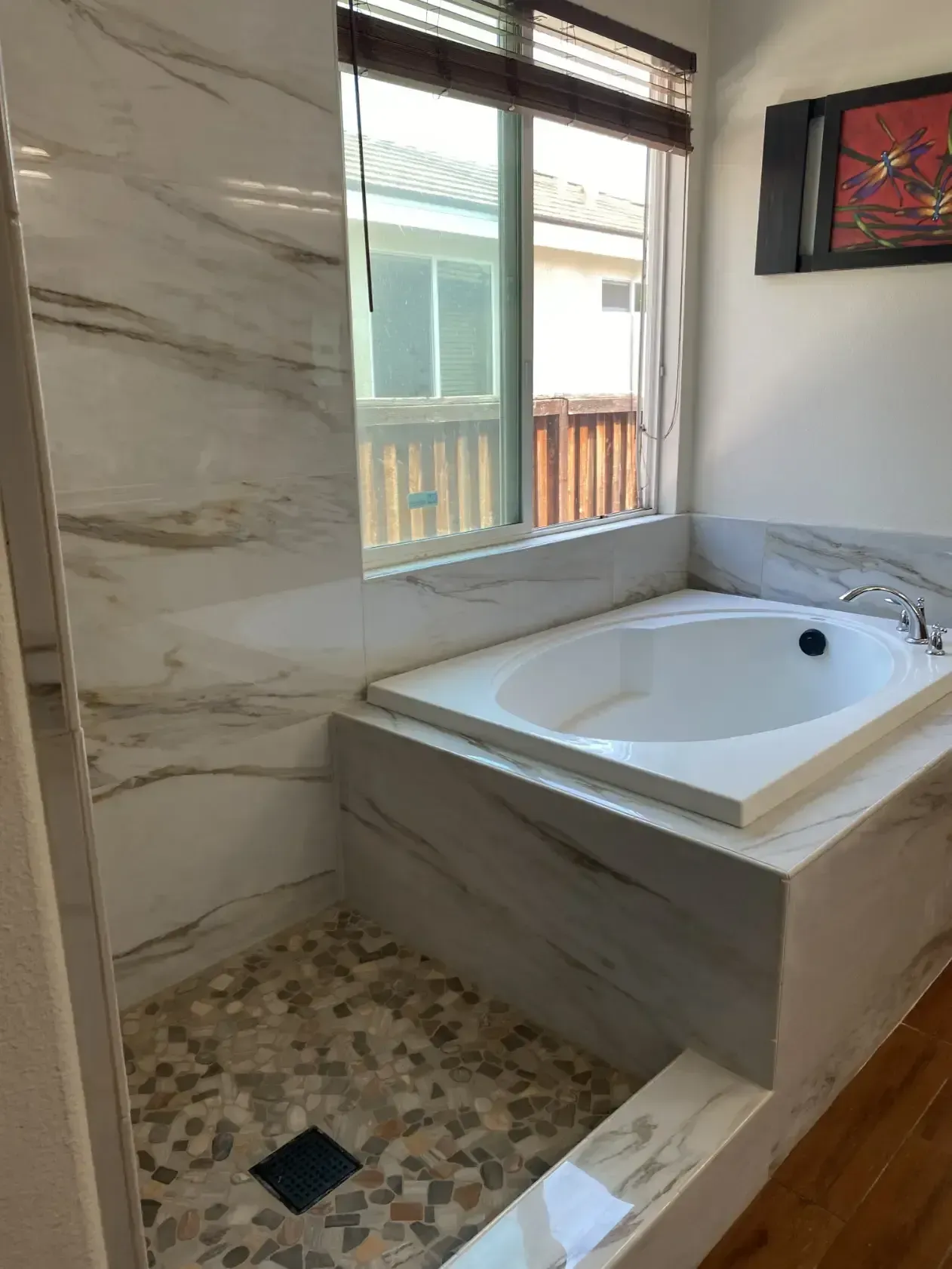 A bathroom with a jacuzzi tub and a walk in shower.