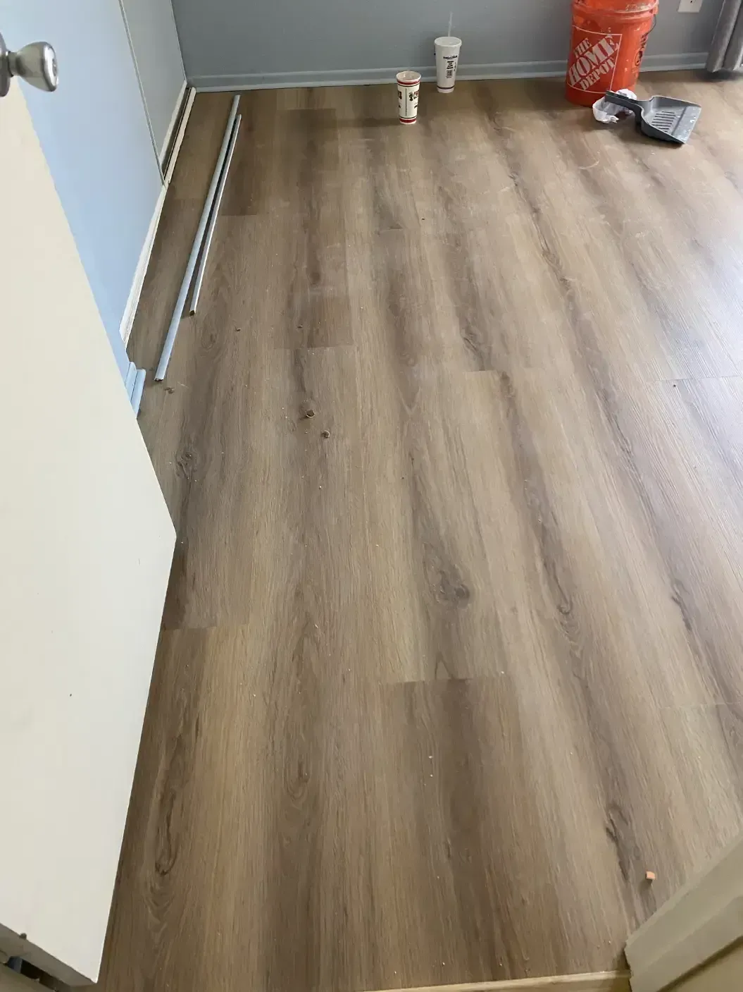 A room with a wooden floor and a door.