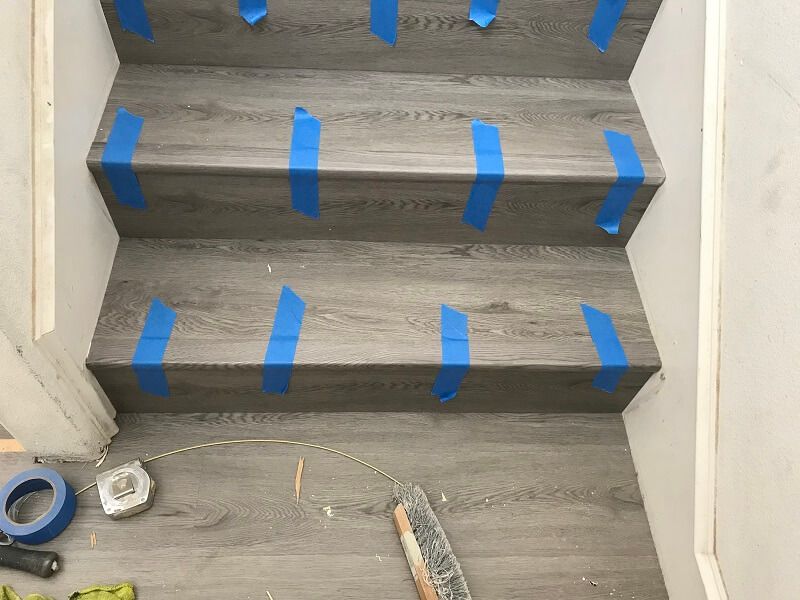 A set of stairs with blue tape on them.