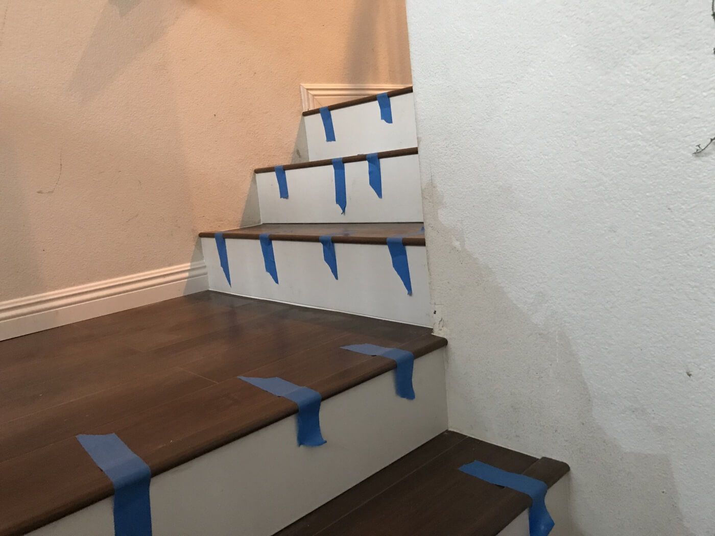 A set of stairs with blue tape on them