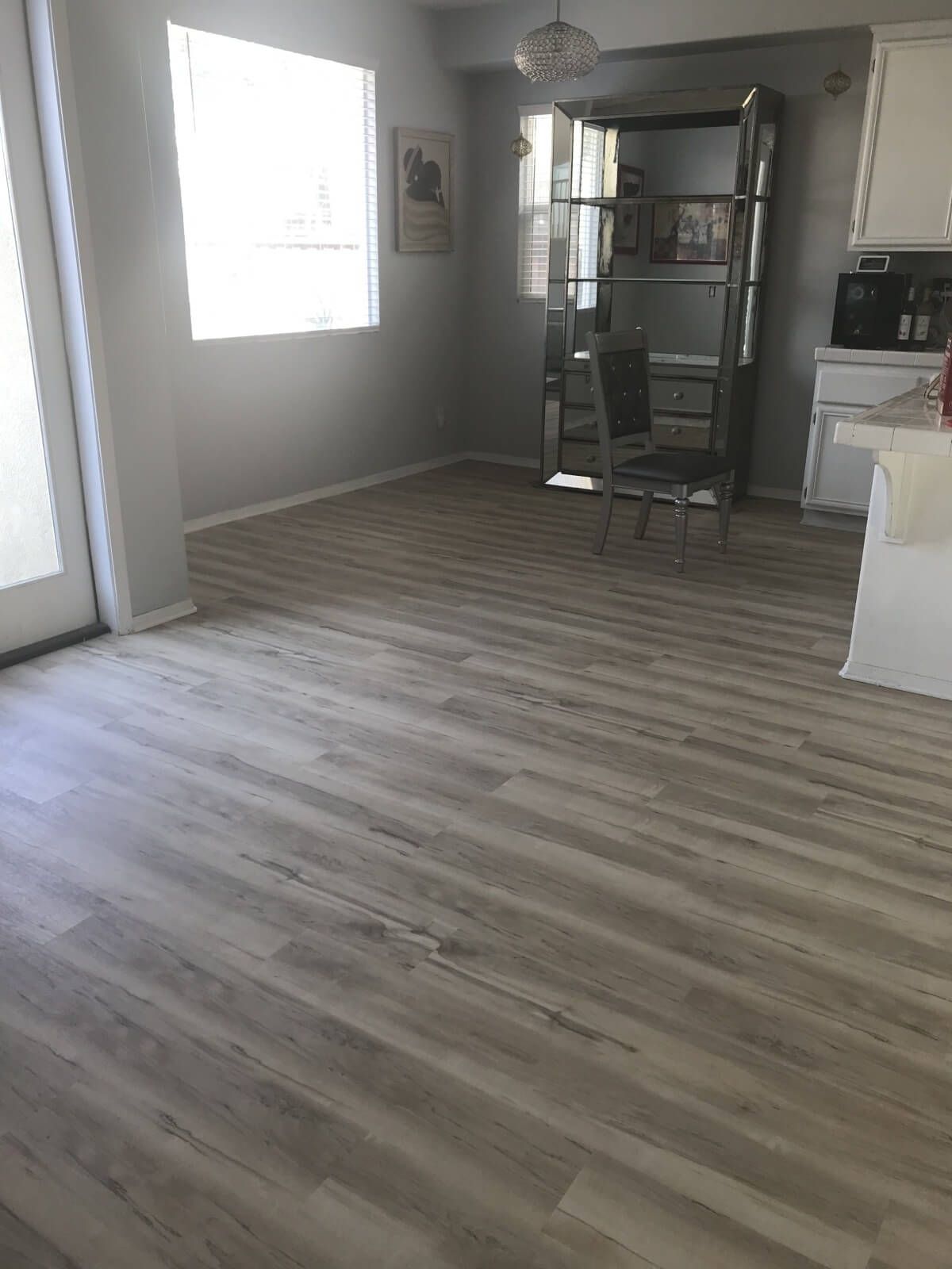 A living room with hardwood floors and a sliding glass door.