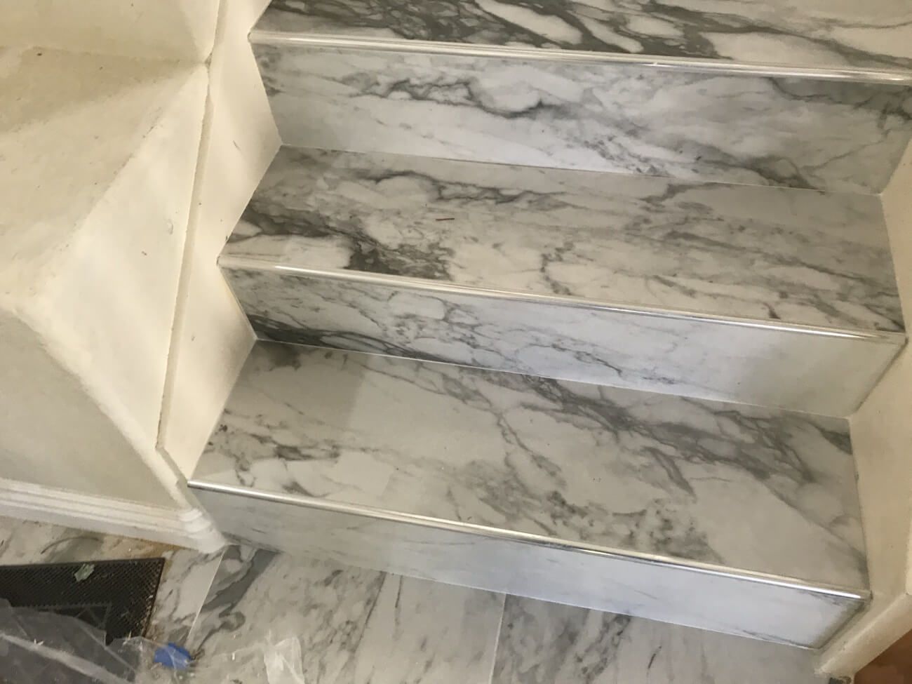 A close up of a set of marble stairs in a room.