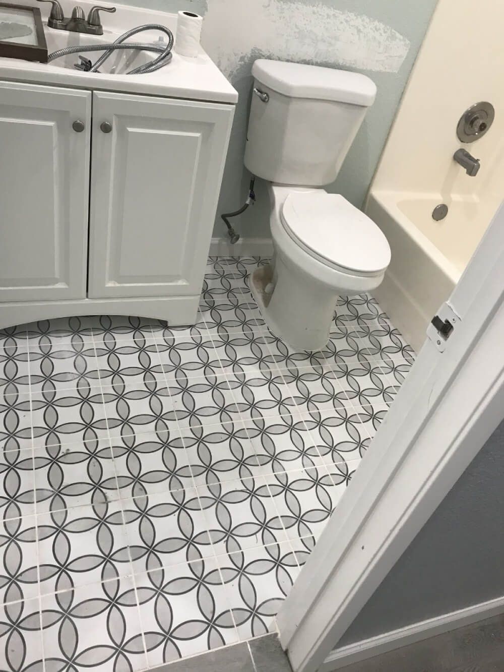 A bathroom with a toilet , sink , and bathtub.