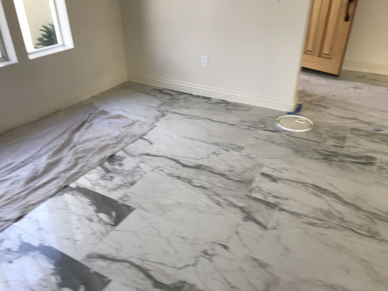 A room with a marble floor and a window.