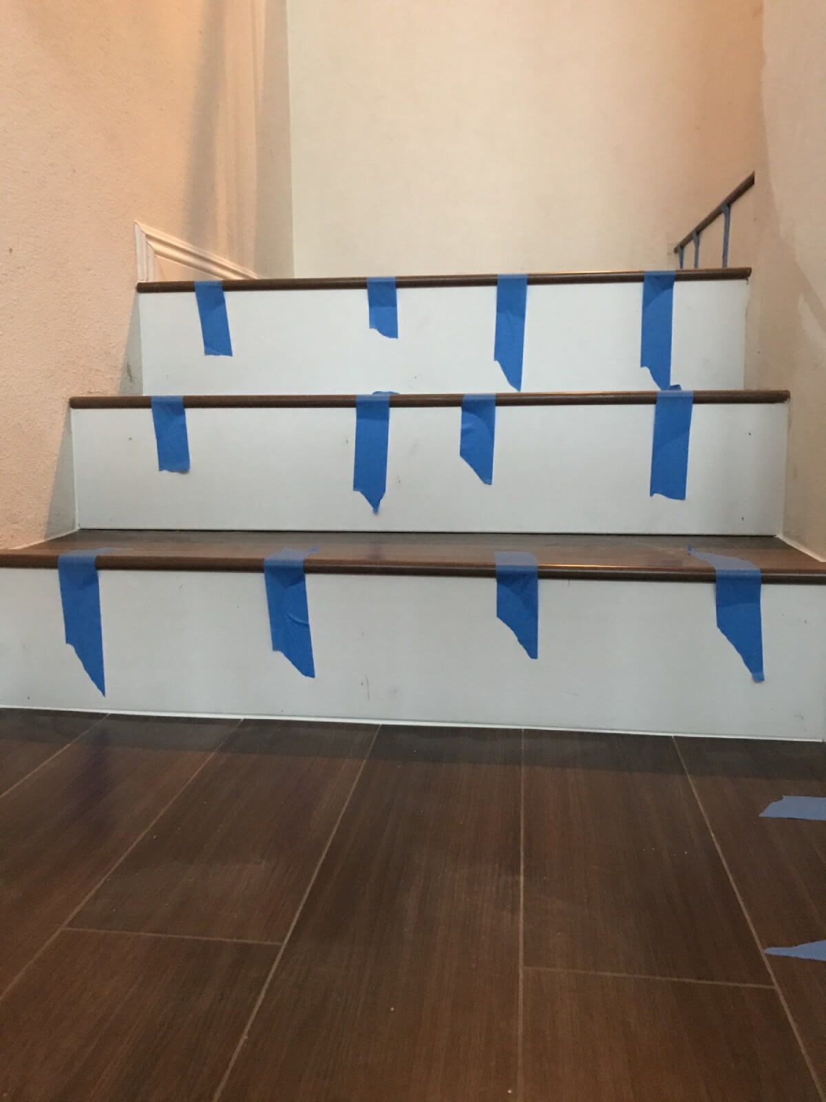 A set of stairs with blue tape on them