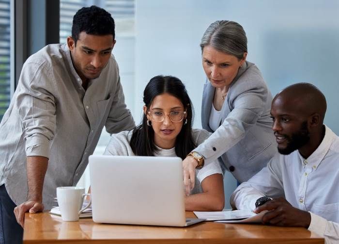 Team looking at a laptop together | Featured image for the SME Accounting Services page of Rudd Mantell Accountants.