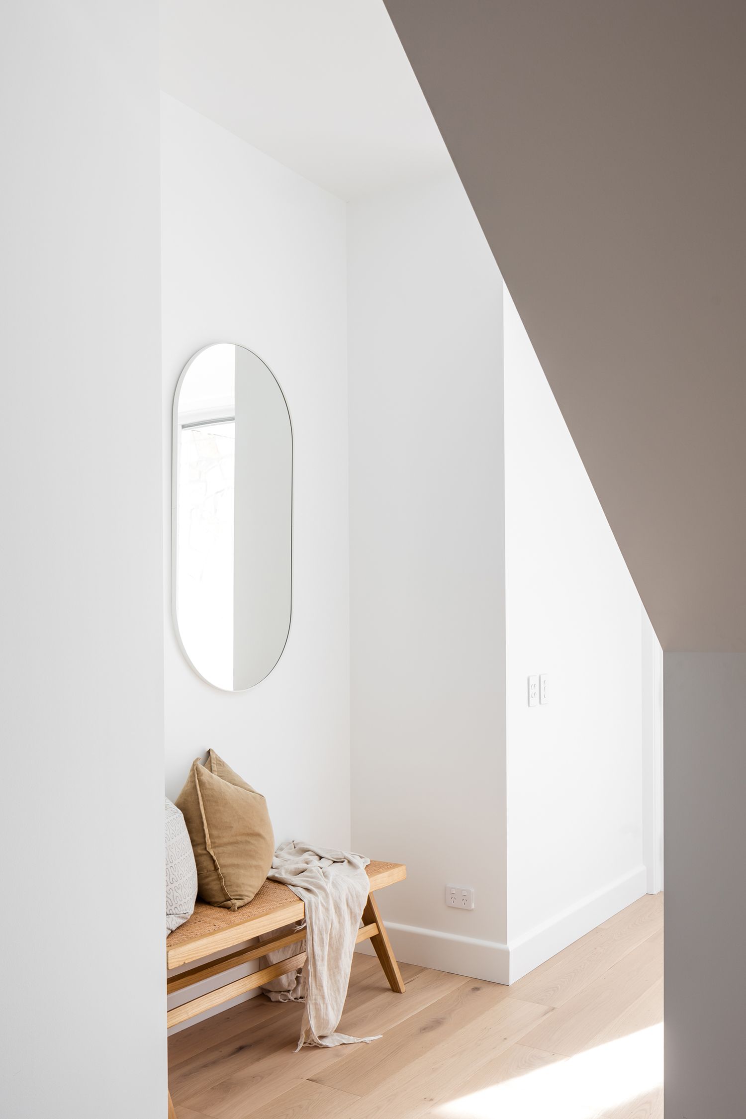 white wall with round mirror at McCourt's Kareela Road project