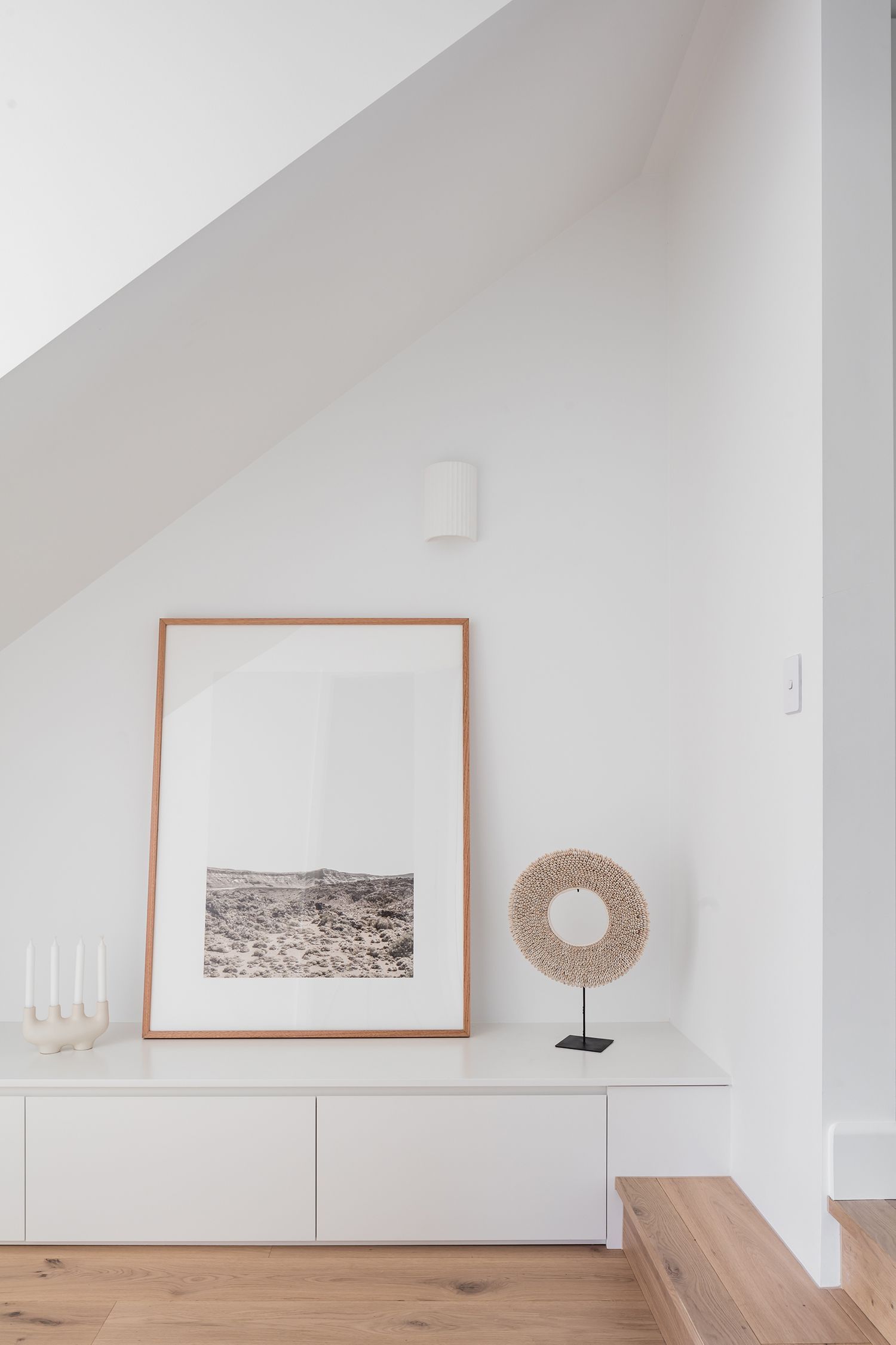 There is a picture on the wall and a wreath on the table at McCourt's Kareela Road project