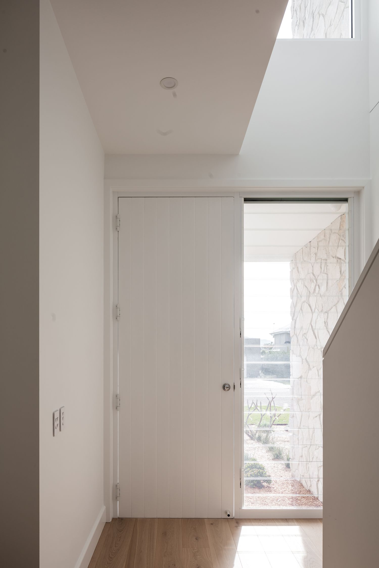 Kareela Road project's hallway with a door and a window in a house.