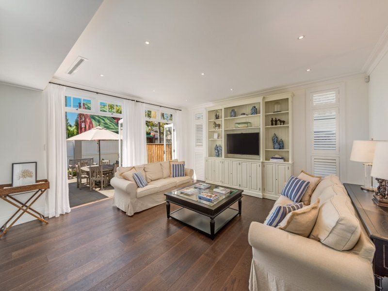A living room with two couches, a coffee table, and a television.