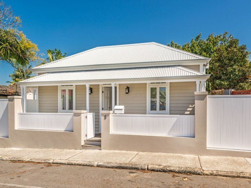 A house with a white roof and a white fence