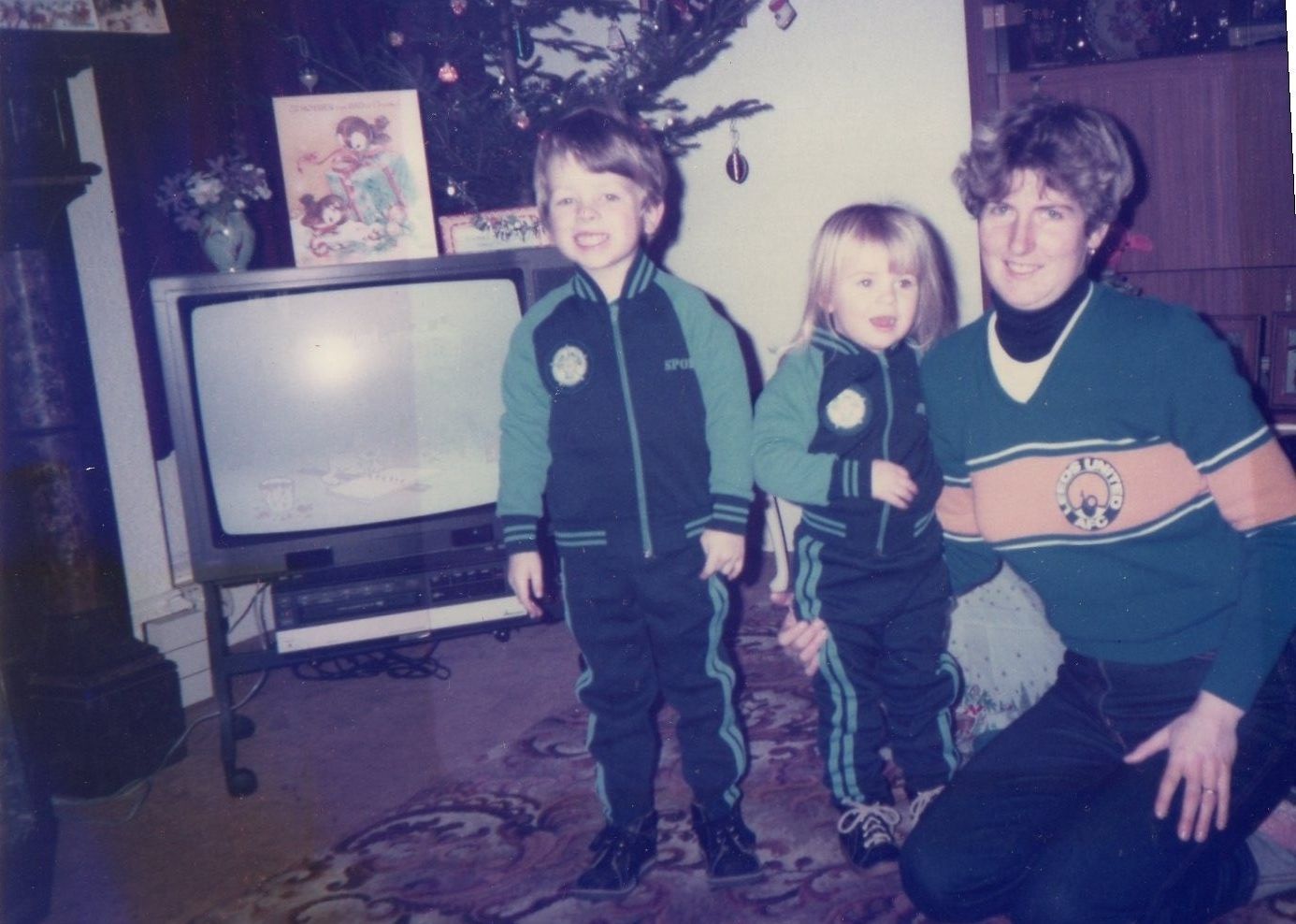 A Heidi Haigh and her two children pose for a picture in front of a television in the late 70s 