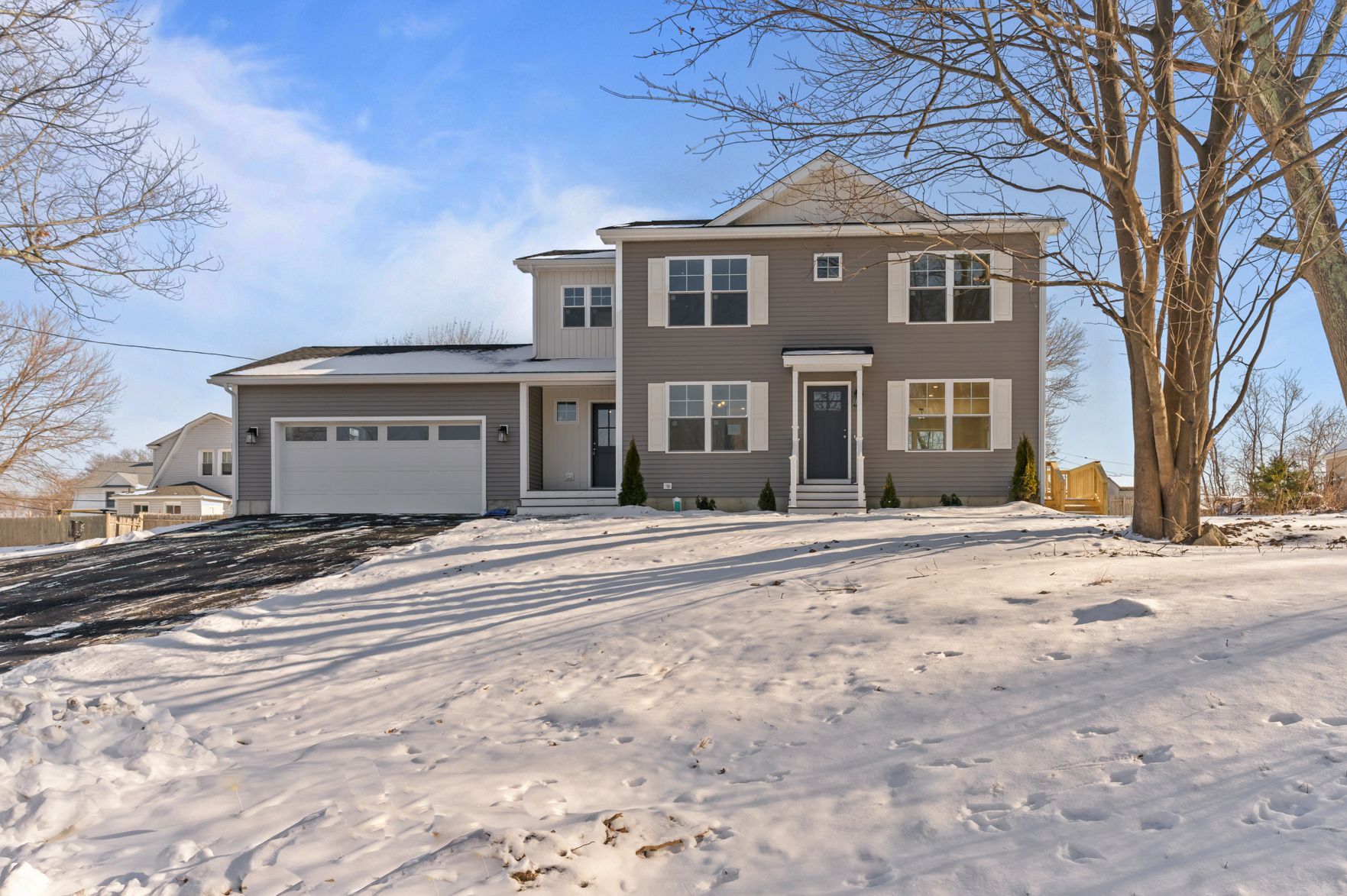 A large house is sitting on top of a snow covered hill.