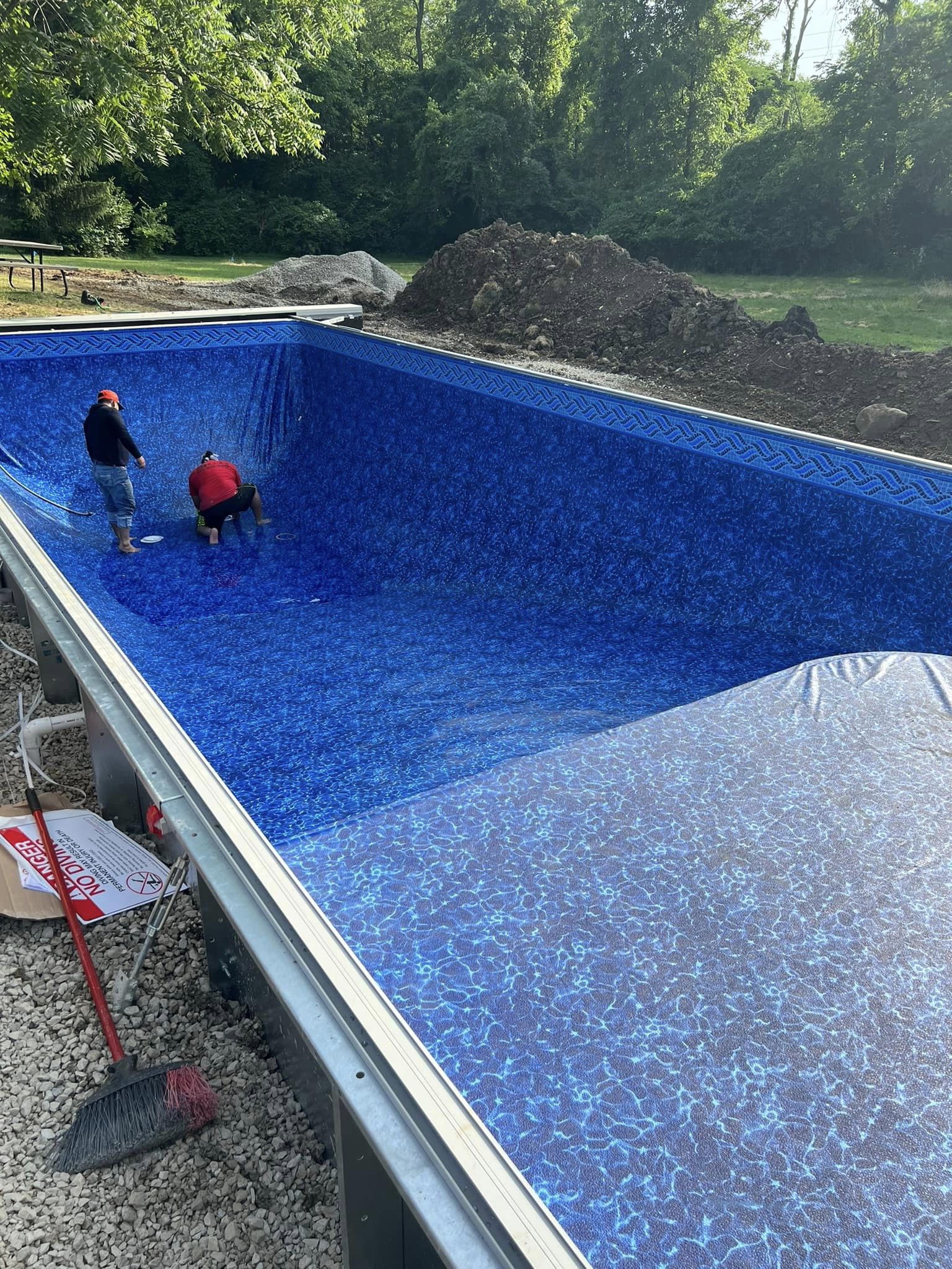 Worker Installing Vinyl Liner Pool - Delaware, OH - Outdoor Living Pools & Patio