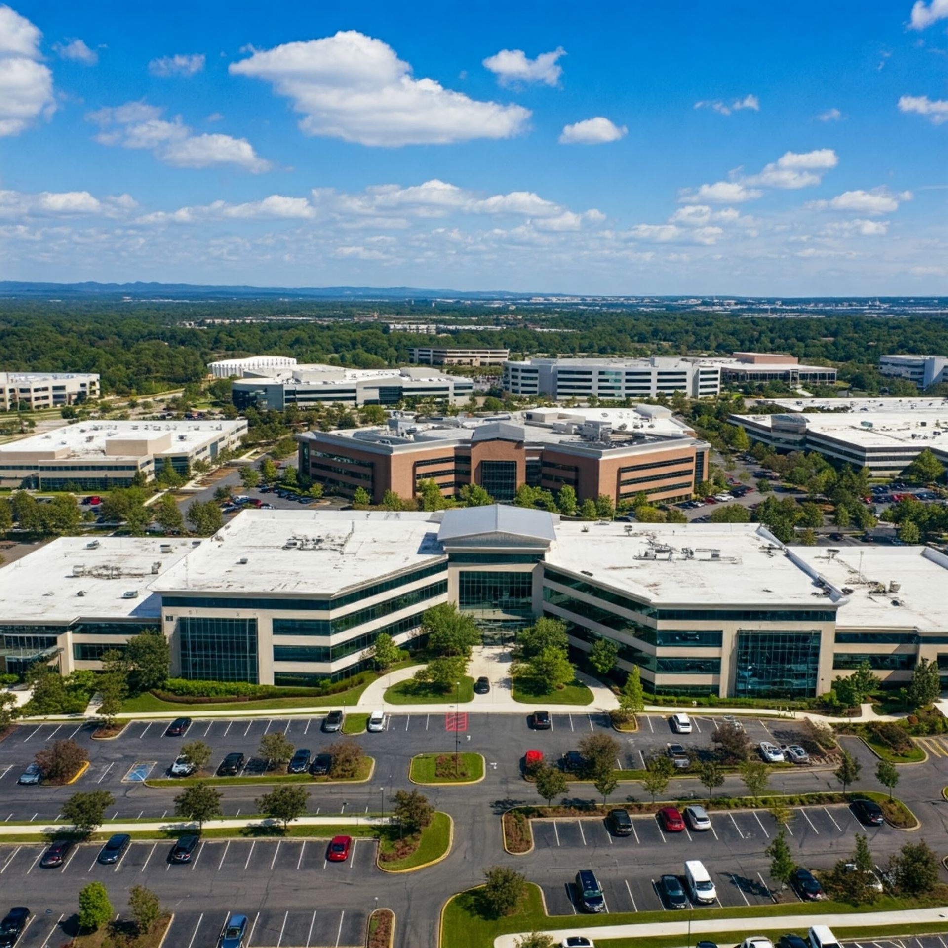 An aerial view of a large building with a lot of cars parked in front of it