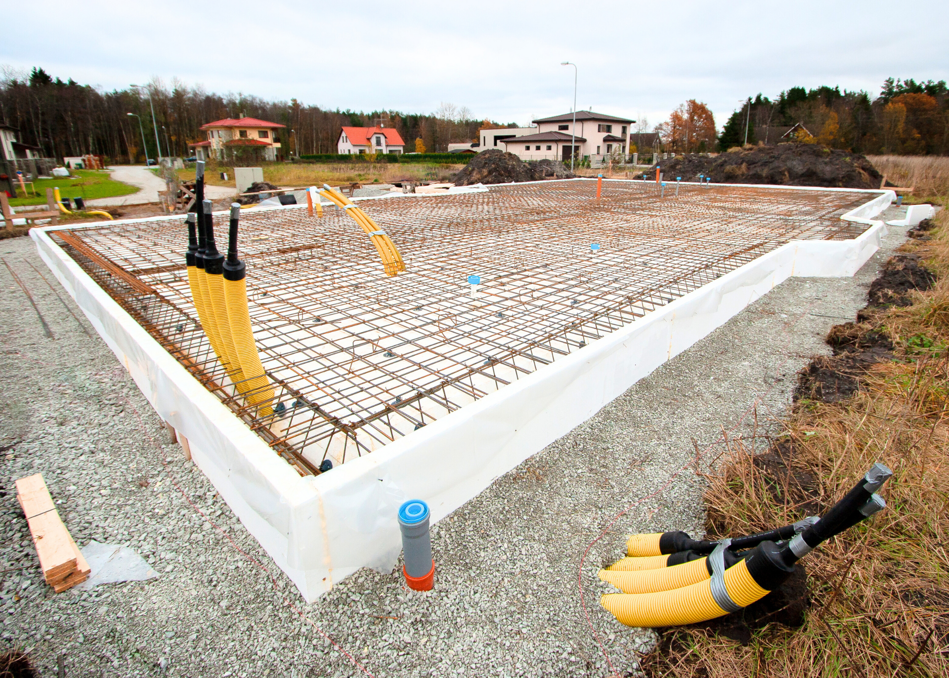 A foundation for a house is being built in a neighborhood