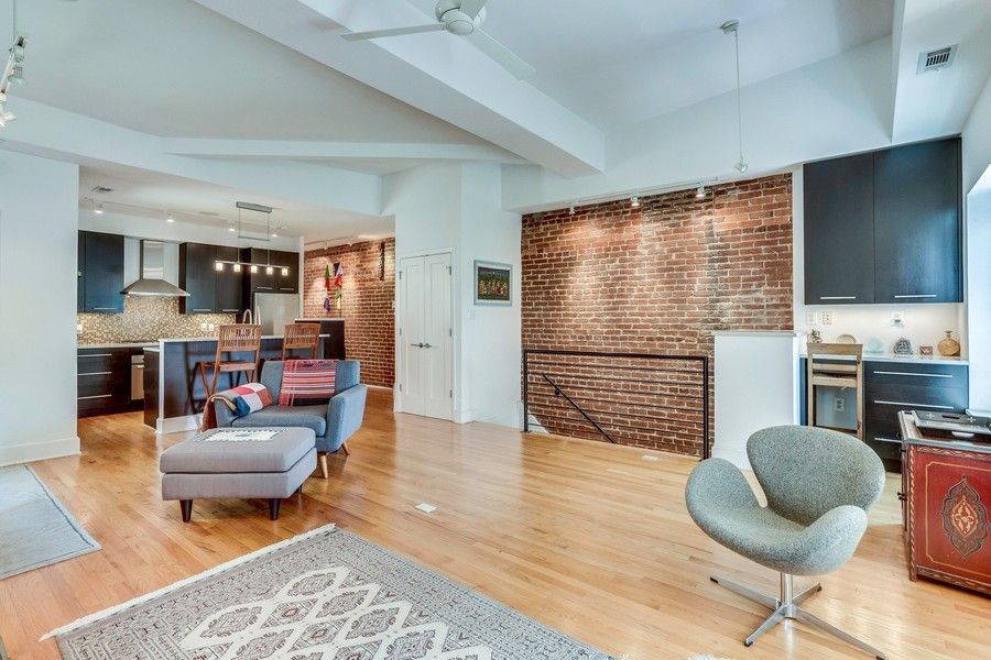Cozy DC living room with couch and exposed brick wall, reflecting the city’s rental property and apa