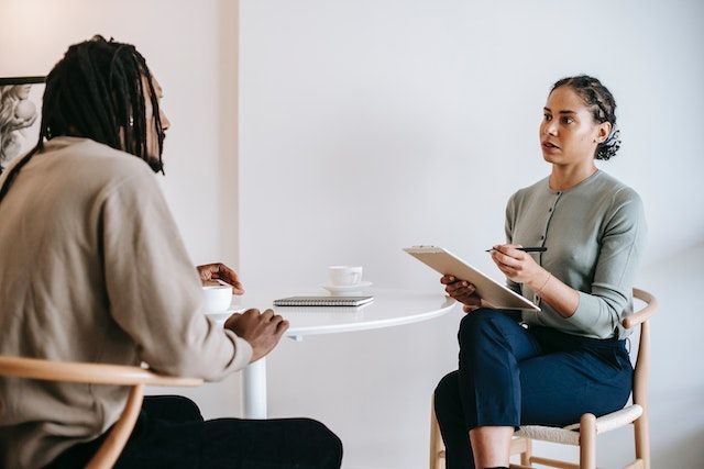 business professional sitting in chair reviewing documents