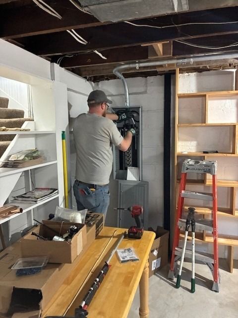 Skilled electrical contractor wiring a residential service upgrade & relocation for safe power.