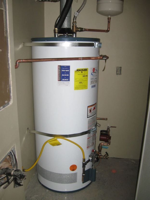 A white water heater with a yellow hose attached to it
