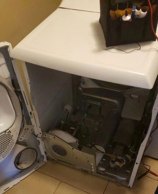 A broken washer and dryer with the door open