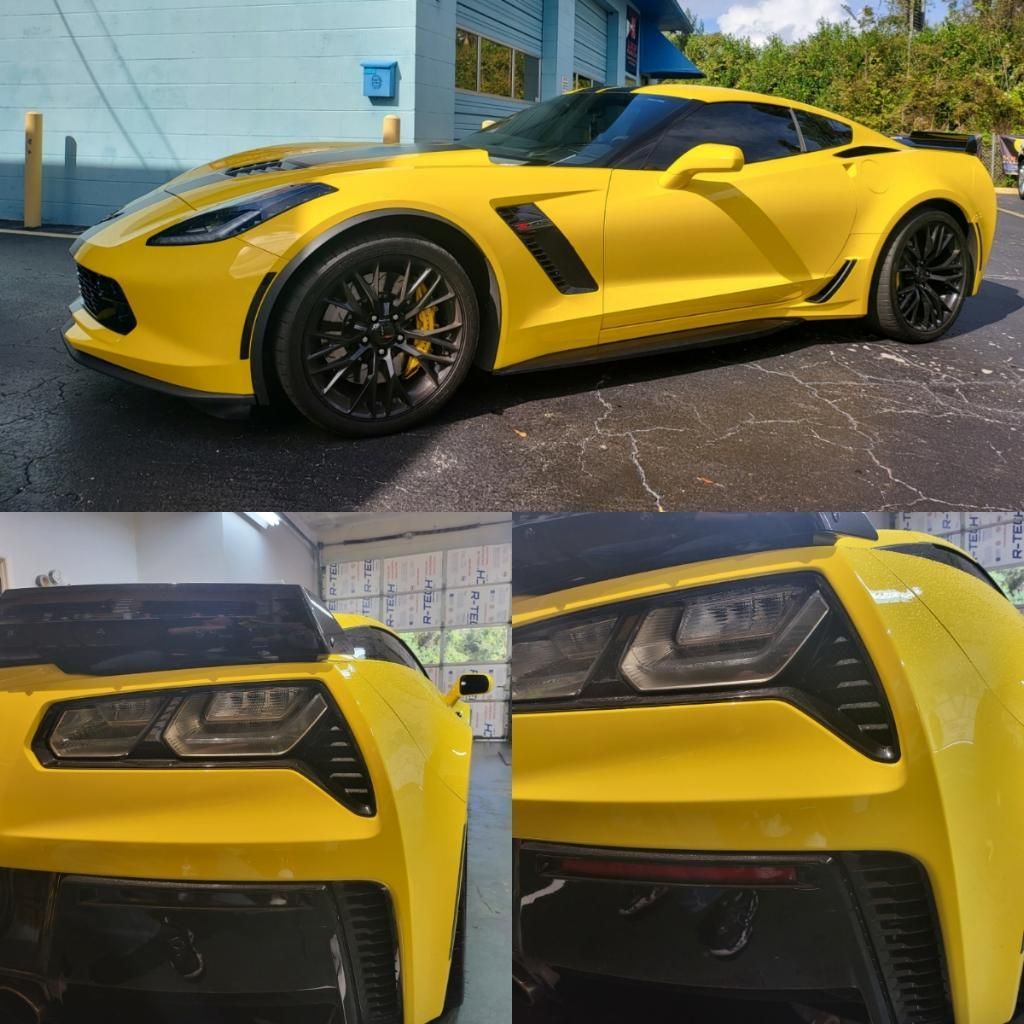 A yellow sports car is parked in front of a garage door