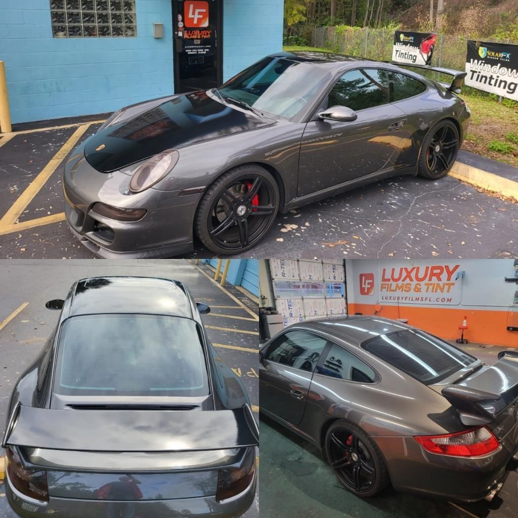A gray sports car is parked in front of a luxury purple tint store