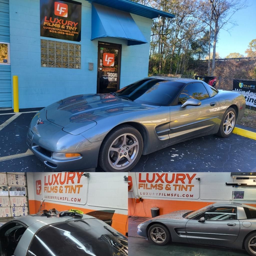 A car is parked in front of a building that says luxury films & tint
