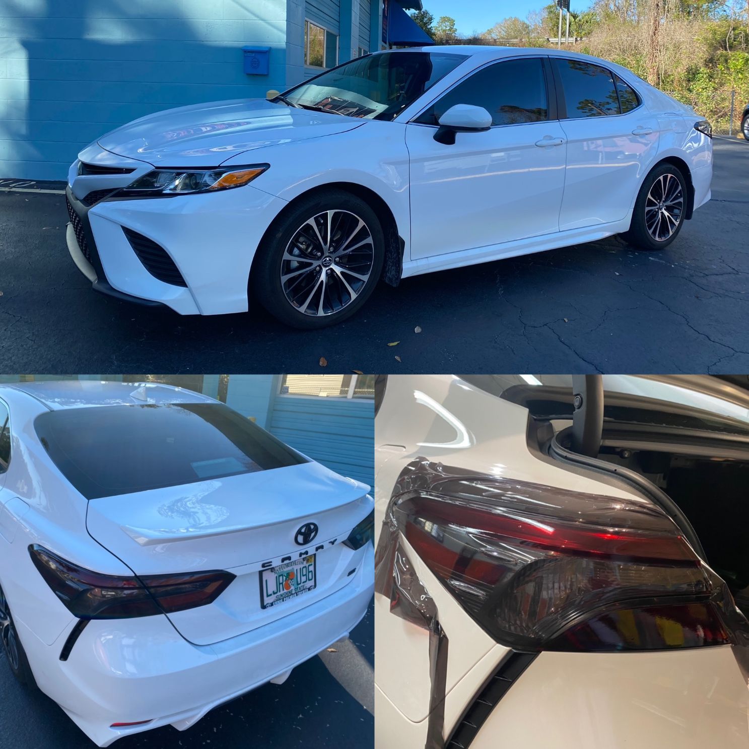 A white toyota camry is parked in front of a blue garage door.