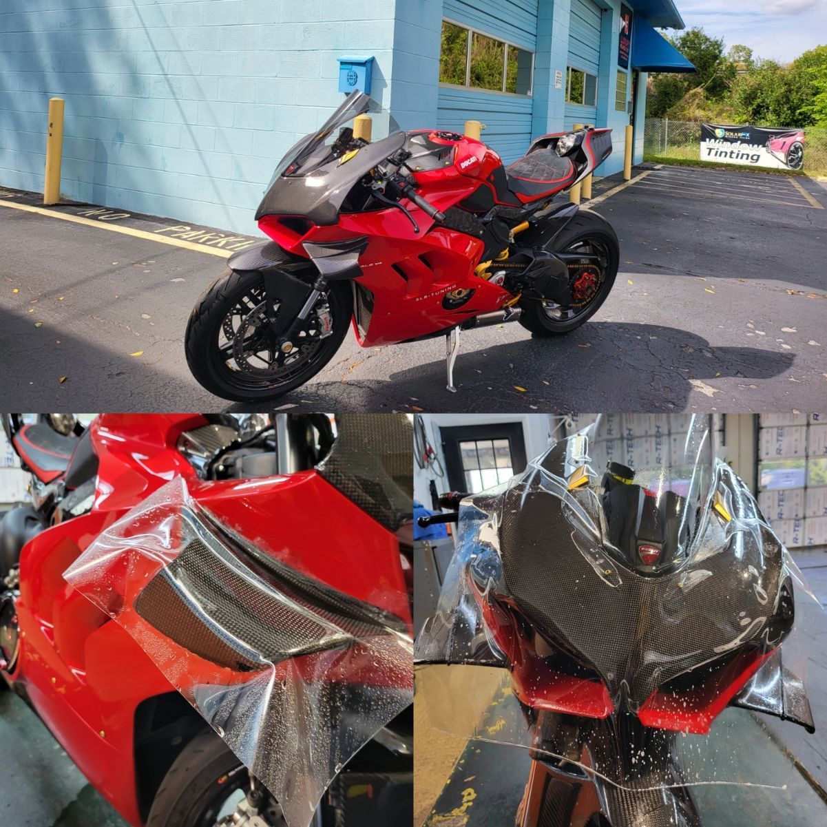 A red motorcycle is parked in front of a garage