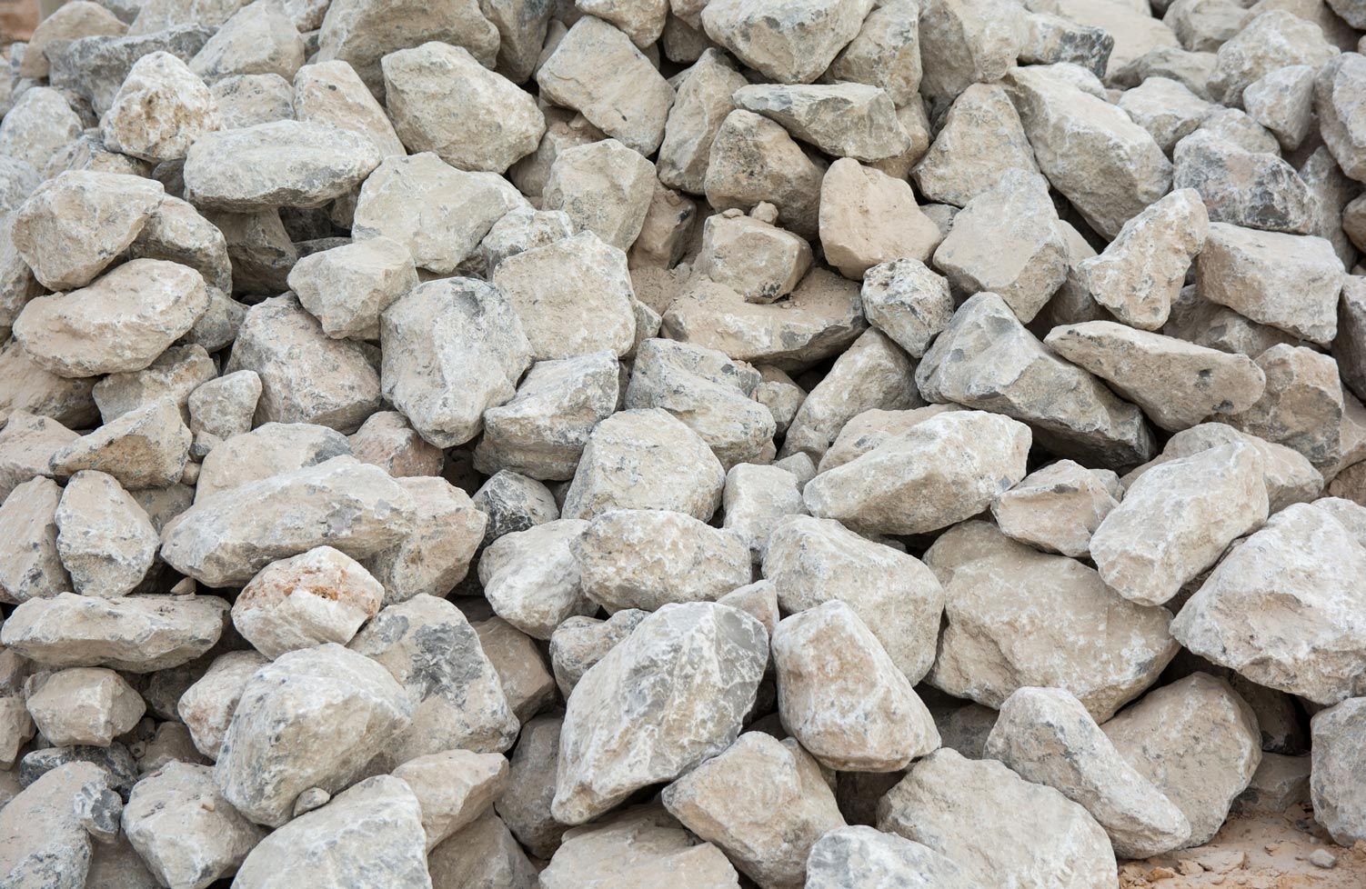 A pile of rocks is sitting on the ground.