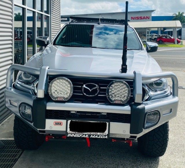 A Silver Mazda Truck Is Parked In Front Of A Nissan Store — Tech Tune Automotive and 4x4 ARB In Mission Beach, QLD