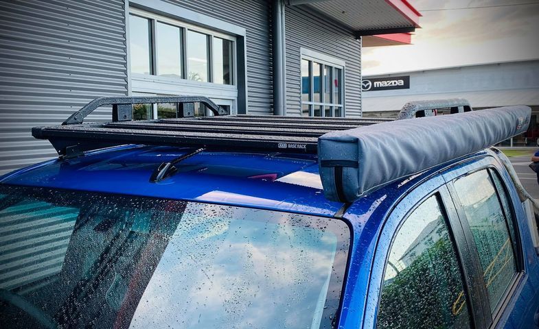 A Blue Car With A Roof Rack On Top Of It Is Parked In Front Of A Building — Tech Tune Automotive and 4x4 ARB In Innisfail, QLD