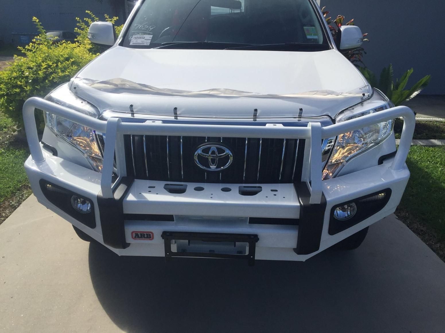 A White Toyota Land Cruiser Is Parked On A Driveway — Tech Tune Automotive and 4x4 ARB In Innisfail, QLD