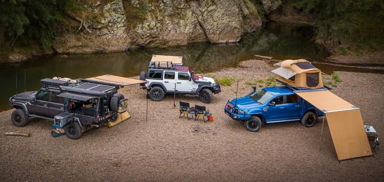 A Group Of Jeep 's Are Parked Next To Each Other On The Side Of A River — Tech Tune Automotive and 4x4 ARB In Innisfail, QLD