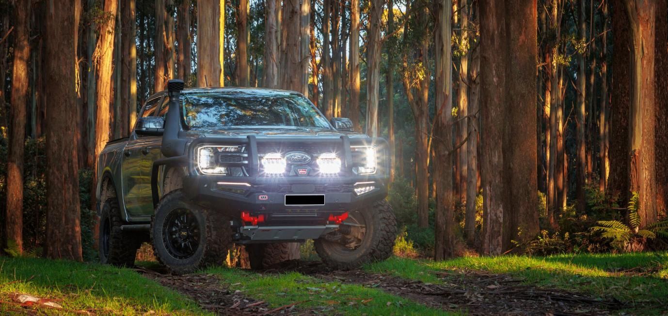 A Truck Is Parked On A Dirt Road In The Middle Of A Forest — Tech Tune Automotive and 4x4 ARB In Innisfail, QLD
