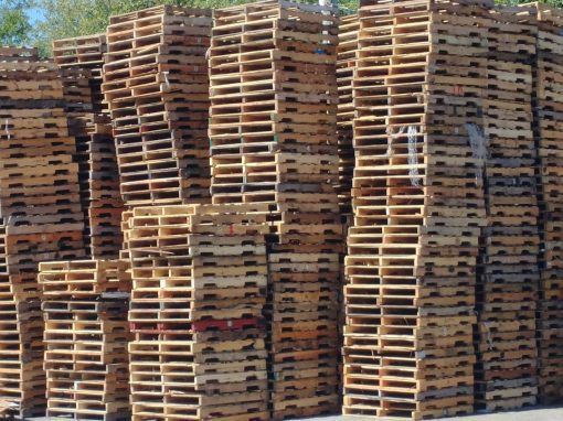The Pallet Pro - Recycled Wood Pallets Stacked For Storage