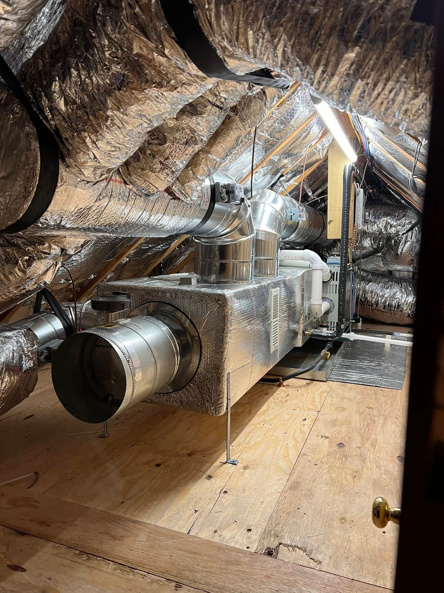 A ventilation system is being installed in an attic.
