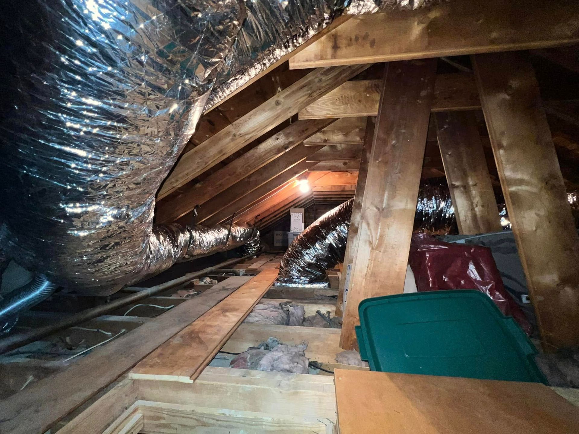 There is a green trash can in the attic.