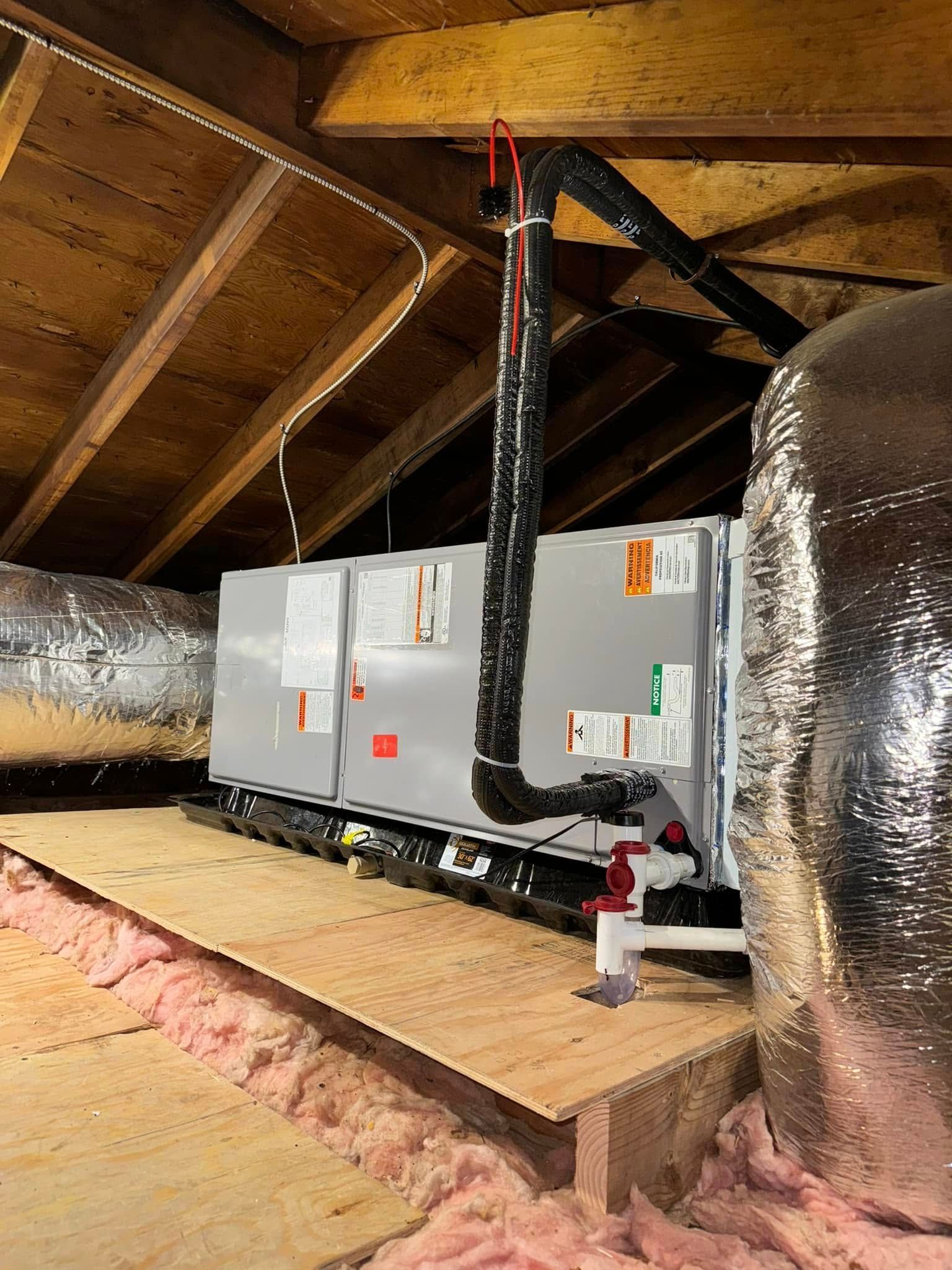 An air conditioner is installed in the attic of a house.