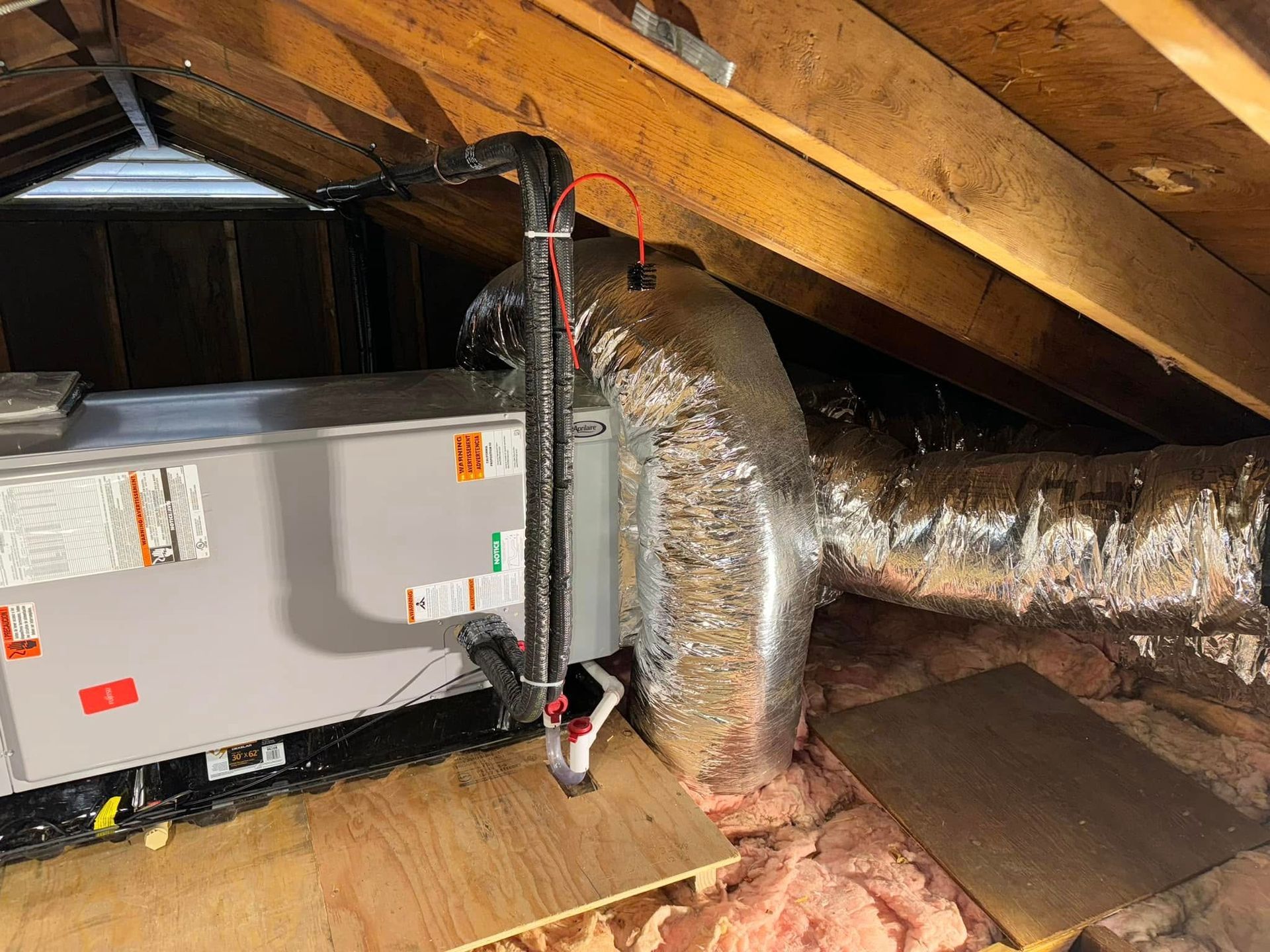 An air conditioner is installed in the attic of a house.