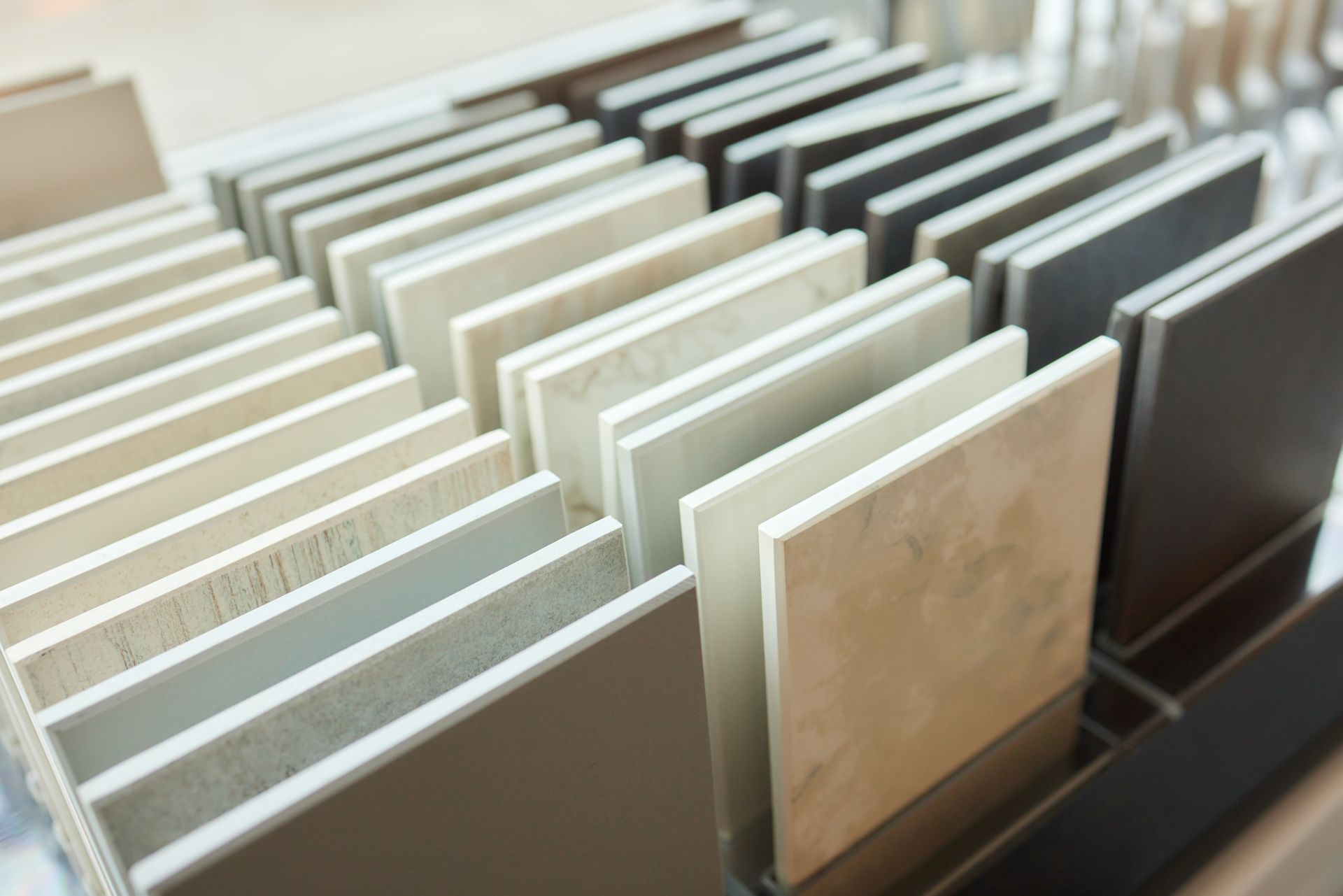 Display of various ceramic tile samples in different colors and textures.