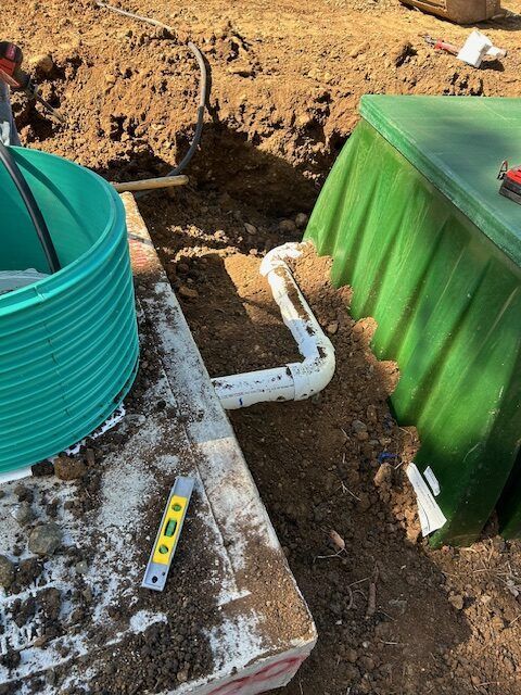 A green bucket is sitting on top of a white table next to a green box.