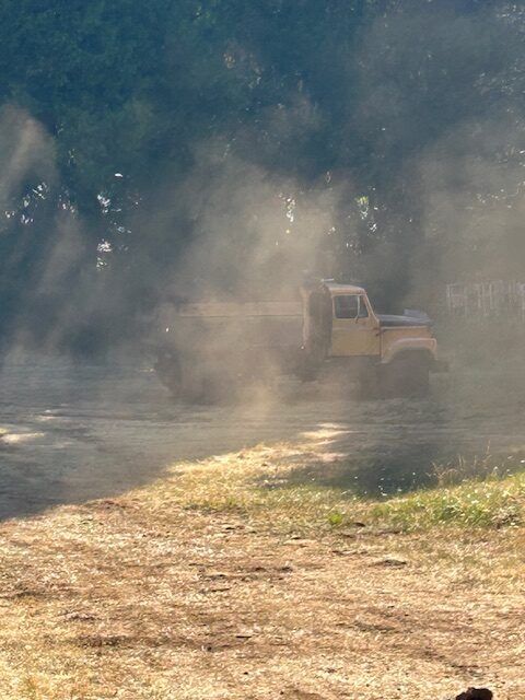 A jeep is driving down a dirt road.