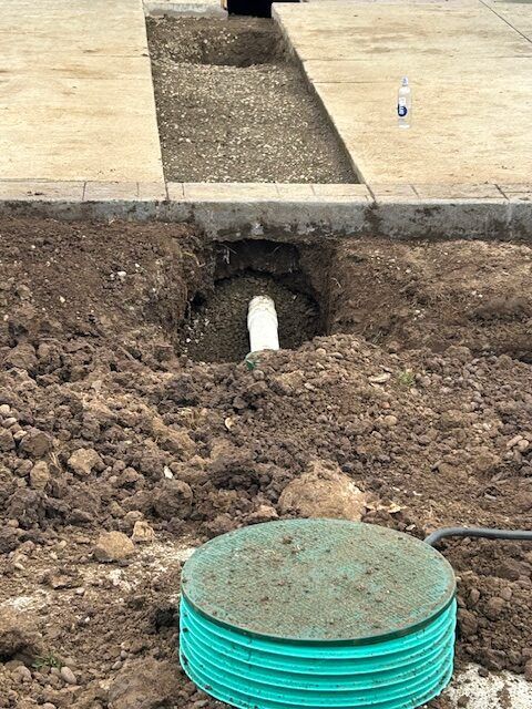 A septic tank is being installed in a hole in the ground.