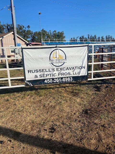 A sign for russell 's excavation and septic pros