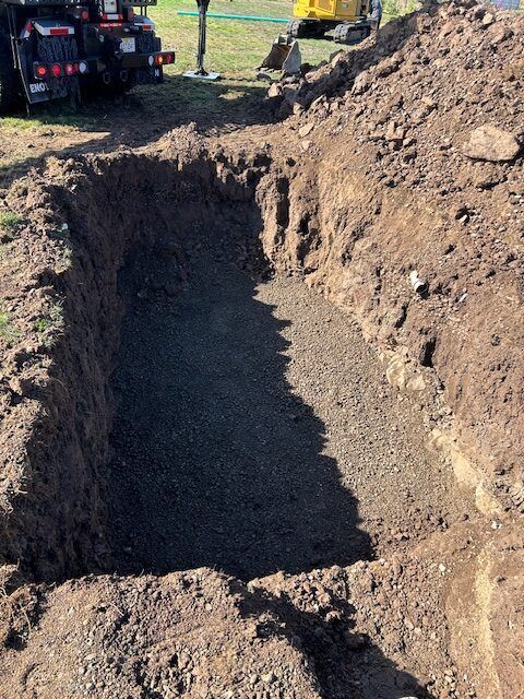 A large pile of dirt is sitting next to a tractor.