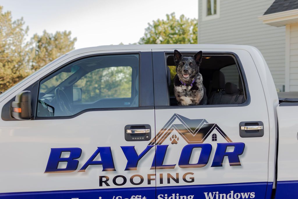 A group of people are working on the roof of a house.