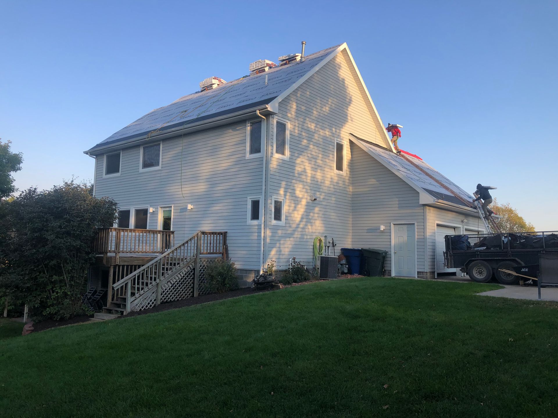 A large white house with solar panels on the roof.