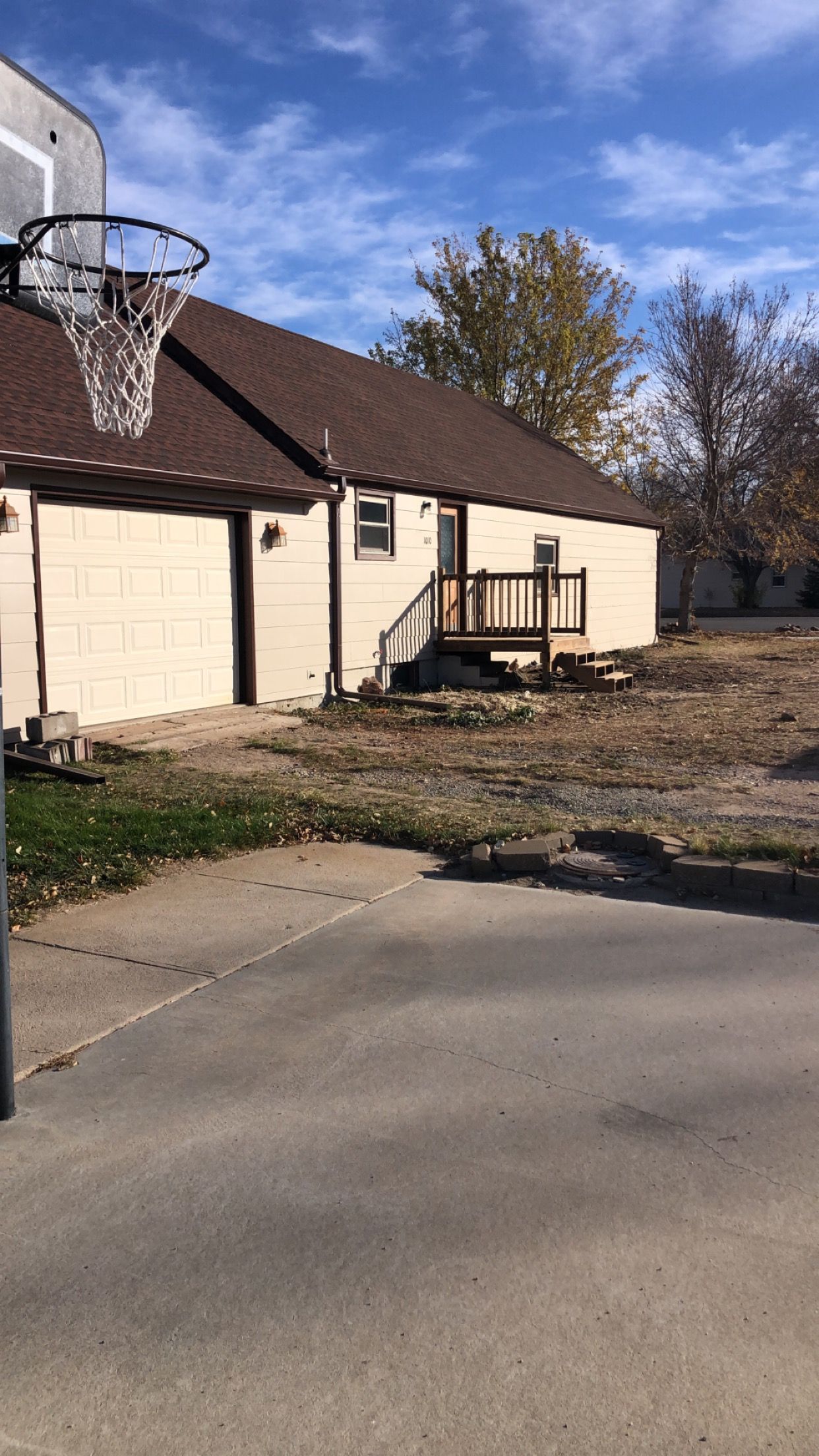 There is a basketball hoop in front of a house.